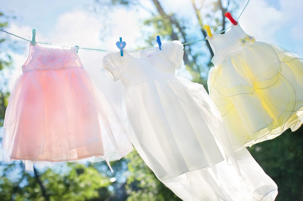 Montessori activities for toddlers include all sort of practical activities. Such as hanging laundry like in this photo.